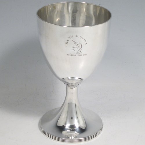 Antique Georgian sterling silver pair of goblets, having plain round bodies, and sitting on pedestal feet with reeded borders. Made by Henry Chawner of London in 1793/94. The dimensions of this fine hand-made pair of silver goblets are height 15 cms (6 inches), diameter at top 8 cms (3.25 inches), and the total weight is approx. 335g (10.8 troy ounces). Please note that both goblets are engraved with crests.