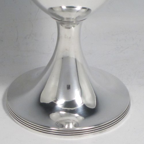 Antique Georgian sterling silver pair of goblets, having plain round bodies, and sitting on pedestal feet with reeded borders. Made by Henry Chawner of London in 1793/94. The dimensions of this fine hand-made pair of silver goblets are height 15 cms (6 inches), diameter at top 8 cms (3.25 inches), and the total weight is approx. 335g (10.8 troy ounces). Please note that both goblets are engraved with crests.