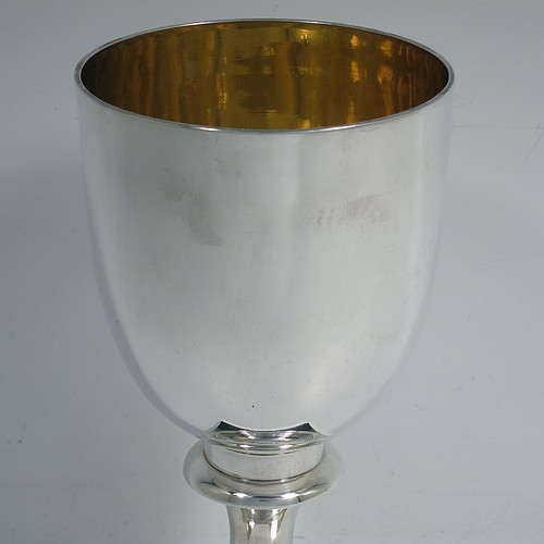 A very handsome Antique Georgian Sterling Silver heavy goblet, having a plain round tapering body with a gold-gilt interior, and sitting on a pedestal foot with reeded decoration and a square base. Made by Thomas Hobbs of London in 1811. The dimensions of this fine hand-made antique silver goblet are height 17 cms (6.75 inches), diameter at lip 9 cms (3.5 inches), and it weighs approx. 312g (10 troy ounces).    