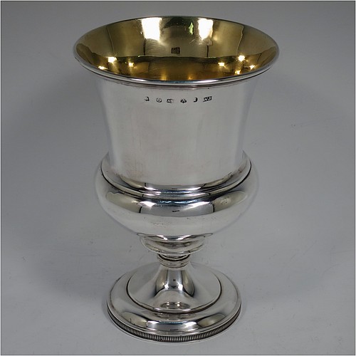 A very handsome Antique Scottish Georgian Sterling Silver wine goblet, having a plain round campania or campagna style bellied body with an applied reeded upper border, a gold-gilt interior, and sitting on a pedestal foot with an applied straight gadroon border. Made by William Jamieson of Edinburgh in 1803. The dimensions of this fine hand-made antique silver campagna or campania style wine goblet are height 15.5 cms (6 inches), diameter at lip 10 cms (4 inches), and it weighs approx. 221g (7 troy ounces).