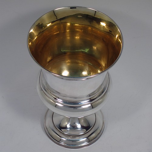 A very handsome Antique Scottish Georgian Sterling Silver wine goblet, having a plain round campania or campagna style bellied body with an applied reeded upper border, a gold-gilt interior, and sitting on a pedestal foot with an applied straight gadroon border. Made by William Jamieson of Edinburgh in 1803. The dimensions of this fine hand-made antique silver campagna or campania style wine goblet are height 15.5 cms (6 inches), diameter at lip 10 cms (4 inches), and it weighs approx. 221g (7 troy ounces).