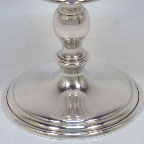 A very handsome Sterling Silver pair of goblets, having plain round tapering bodies with gold-gilt interiors, and sitting on pedestal feet with baluster stems and reeded borders. Made by Trevor Towner of London in 1973. The dimensions of this fine pair of hand-made silver goblets are height 12.5 cms (5 inches), diameter at lip 7.5 cms (3 inches), and they weigh a total of approx. 300g (9.7 troy ounces).   