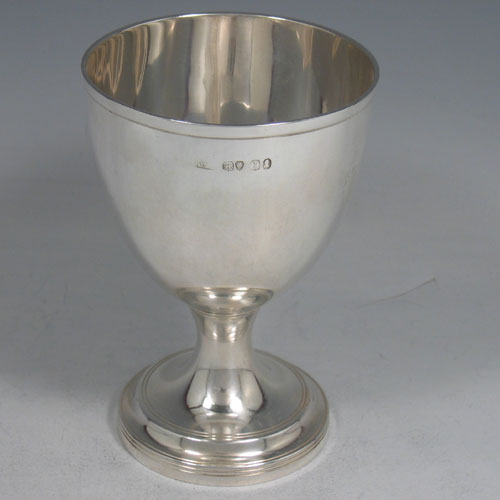 A very elegant Antique Georgian Sterling Silver goblet, having a plain round tapering body with reeded borders, and sitting on a pedestal foot. This handsome antique silver goblet was made by William Bateman (poss.) of London in 1826. The dimensions of this fine hand-made silver goblet are height 12.5 cms (5 inches), diameter at lip 9 cms (3.5 inches), and it weighs approx. 168g (5.4 troy ounces).
