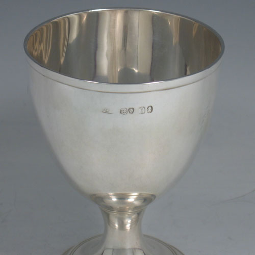 A very elegant Antique Georgian Sterling Silver goblet, having a plain round tapering body with reeded borders, and sitting on a pedestal foot. This handsome antique silver goblet was made by William Bateman (poss.) of London in 1826. The dimensions of this fine hand-made silver goblet are height 12.5 cms (5 inches), diameter at lip 9 cms (3.5 inches), and it weighs approx. 168g (5.4 troy ounces).
