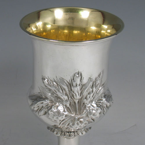 Antique Victorian sterling silver goblet, having a round campagna style body with hand-chased wheat-sheaf decoration, a gold-gilt interior, and sitting on a pedestal foot. Made by George and Charles Fox of London in 1845. The dimensions of this fine hand-made silver goblet are height 15 cms (6 inches), diameter at lip 9 cms (3.5 inches), and it weighs approx. 170g (5.5 troy ounces).
