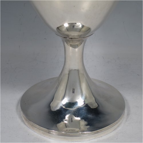 An Antique Georgian Sterling Silver wine goblet, having a plain round tapering body with reeded borders, and sitting on a pedestal foot. Made by John Robbins of London in 1798. The dimensions of this fine hand-made antique silver goblet are height 19 cms (7.5 inches), diameter at lip 10 cms (4 inches), and it weighs approx. 248g (8 troy ounces).    