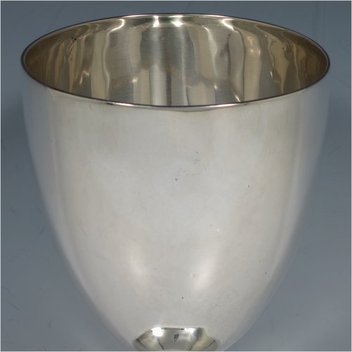 An Antique Georgian Sterling Silver wine goblet, having a plain round tapering body with reeded borders, and sitting on a pedestal foot. Made by John Robbins of London in 1798. The dimensions of this fine hand-made antique silver goblet are height 19 cms (7.5 inches), diameter at lip 10 cms (4 inches), and it weighs approx. 248g (8 troy ounces).    