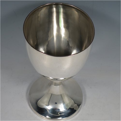 An Antique Georgian Sterling Silver wine goblet, having a plain round tapering body with reeded borders, and sitting on a pedestal foot. Made by John Robbins of London in 1798. The dimensions of this fine hand-made antique silver goblet are height 19 cms (7.5 inches), diameter at lip 10 cms (4 inches), and it weighs approx. 248g (8 troy ounces).    