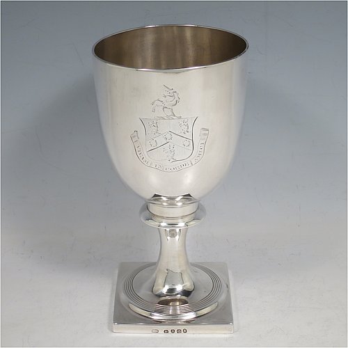 An Antique Georgian Sterling Silver heavy goblet, having a plain round tapering body, and sitting on a pedestal foot with reeded decoration and a square base. Made by Thomas Hayyer of London in 1811. The dimensions of this fine hand-made antique silver goblet are height 17 cms (6.3 inches), diameter at lip 9 cms (3.5 inches), and it weighs approx. 372g (12 troy ounces). Please note that this item is crested.