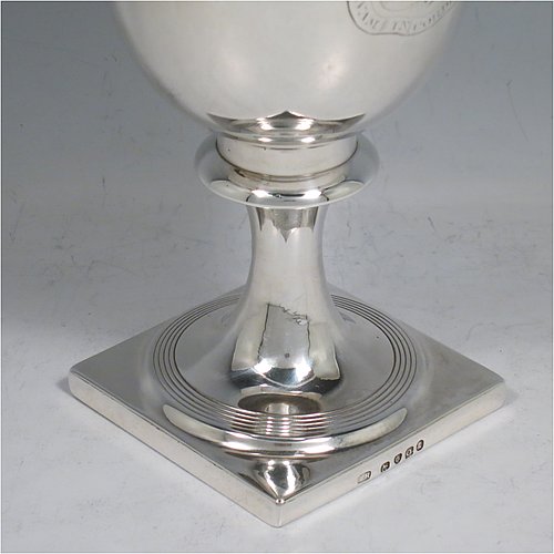 An Antique Georgian Sterling Silver heavy goblet, having a plain round tapering body, and sitting on a pedestal foot with reeded decoration and a square base. Made by Thomas Hayyer of London in 1811. The dimensions of this fine hand-made antique silver goblet are height 17 cms (6.3 inches), diameter at lip 9 cms (3.5 inches), and it weighs approx. 372g (12 troy ounces). Please note that this item is crested.