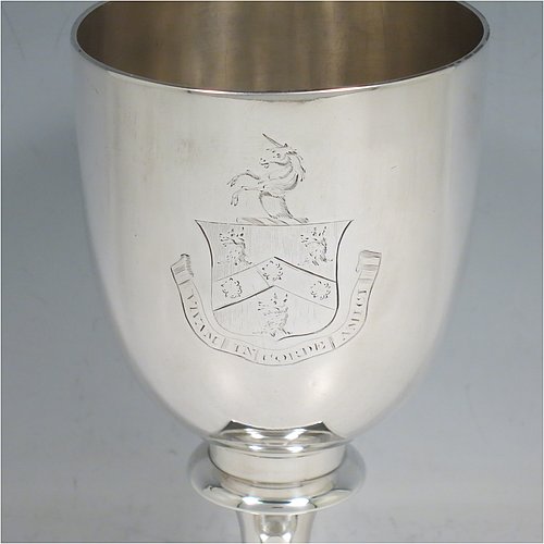 An Antique Georgian Sterling Silver heavy goblet, having a plain round tapering body, and sitting on a pedestal foot with reeded decoration and a square base. Made by Thomas Hayyer of London in 1811. The dimensions of this fine hand-made antique silver goblet are height 17 cms (6.3 inches), diameter at lip 9 cms (3.5 inches), and it weighs approx. 372g (12 troy ounces). Please note that this item is crested.