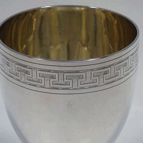 A large and very handsome Antique Georgian Sterling Silver goblet, having a round tapering body with a top band of hand-engraved Greek-key decoration, sitting on a pedestal foot with a reeded border, and with a gold-gilt interior. Made in London in 1804. The dimensions of this fine hand-made antique silver goblet are height 16.5 cms (6.5 inches), diameter at lip 9 cms (3.5 inches), and it weighs approx. 278g (9 troy ounces).    