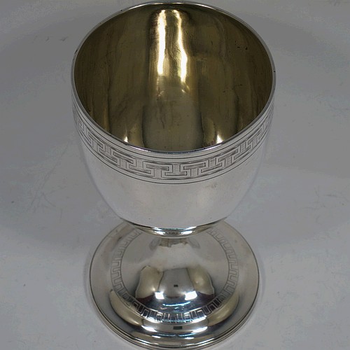 A large and very handsome Antique Georgian Sterling Silver goblet, having a round tapering body with a top band of hand-engraved Greek-key decoration, sitting on a pedestal foot with a reeded border, and with a gold-gilt interior. Made in London in 1804. The dimensions of this fine hand-made antique silver goblet are height 16.5 cms (6.5 inches), diameter at lip 9 cms (3.5 inches), and it weighs approx. 278g (9 troy ounces).    