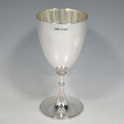 A pretty Antique Victorian Sterling Silver goblet, having a plain round tapering body, and sitting on a pedestal foot with an applied bead border. Made by James Dixon and Sons of Sheffield in 1895. The dimensions of this fine hand-made antique silver goblet are height 17 cms (6.75 inches), diameter at lip 8 cms (3 inches), and it weighs approx. 186g (6 troy ounces).