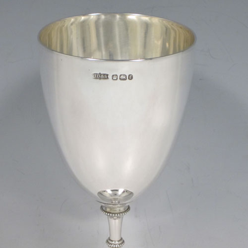 A pretty Antique Victorian Sterling Silver goblet, having a plain round tapering body, and sitting on a pedestal foot with an applied bead border. Made by James Dixon and Sons of Sheffield in 1895. The dimensions of this fine hand-made antique silver goblet are height 17 cms (6.75 inches), diameter at lip 8 cms (3 inches), and it weighs approx. 186g (6 troy ounces).