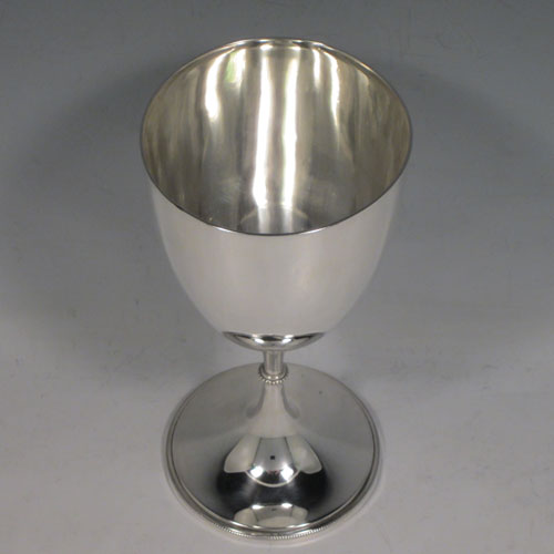 A pretty Antique Victorian Sterling Silver goblet, having a plain round tapering body, and sitting on a pedestal foot with an applied bead border. Made by James Dixon and Sons of Sheffield in 1895. The dimensions of this fine hand-made antique silver goblet are height 17 cms (6.75 inches), diameter at lip 8 cms (3 inches), and it weighs approx. 186g (6 troy ounces).