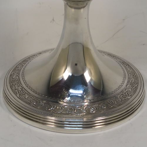 A very pretty Antique Georgian Sterling Silver goblet, having a round tapering body with a top band of hand-engraved floral and scroll decoration, sitting on a pedestal foot with a reeded border and matching engraving, and with a gold-gilt interior. This beautiful antique silver goblet was made John Emes of London in 1804. The dimensions of this fine hand-made antique silver goblet are height 14 cms (5.5 inches), diameter at lip 8 cms (3 inches), and it weighs approx. 158g (5 troy ounces).   