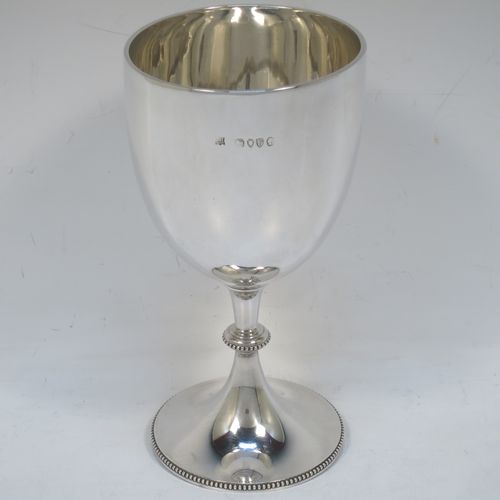 A pretty Antique Victorian Sterling Silver goblet, having a plain round tapering body, and sitting on a pedestal foot with an applied bead-edged border. Made by Edward Hutton of London in 1881. The dimensions of this fine hand-made antique silver goblet are height 16 cms (6.3 inches), diameter at lip 8.5 cms (3.3 inches), and it weighs approx. 212g (6.8 troy ounces).  