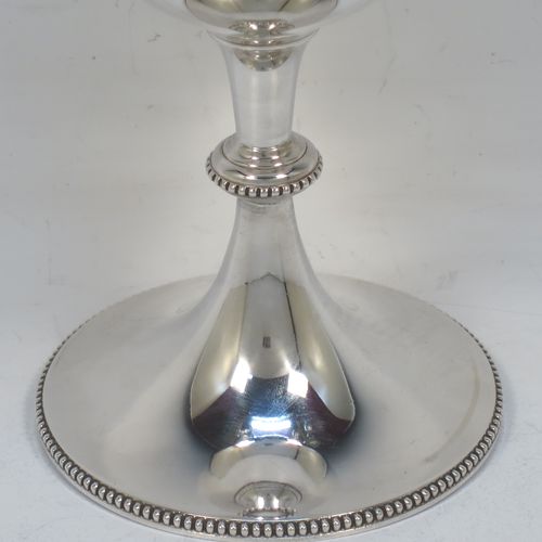 A pretty Antique Victorian Sterling Silver goblet, having a plain round tapering body, and sitting on a pedestal foot with an applied bead-edged border. Made by Edward Hutton of London in 1881. The dimensions of this fine hand-made antique silver goblet are height 16 cms (6.3 inches), diameter at lip 8.5 cms (3.3 inches), and it weighs approx. 212g (6.8 troy ounces).  