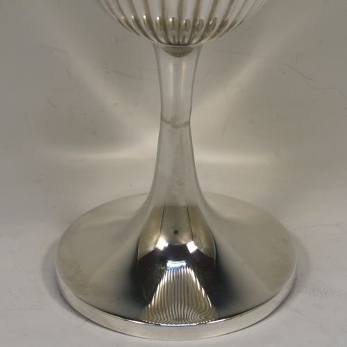 A large and elegant Antique Victorian Sterling Silver goblet, having a round tapering body with hand-chased half-fluted decoration, sitting on a plain round pedestal foot. This handsome antique silver goblet was made by the Deakin Brothers of Sheffield in 1899. The dimensions of this fine hand-made antique silver goblet are height 20.5 cms (8 inches), diameter at lip 10 cms (4 inches), and it weighs approx. 220g (7 troy ounces).   