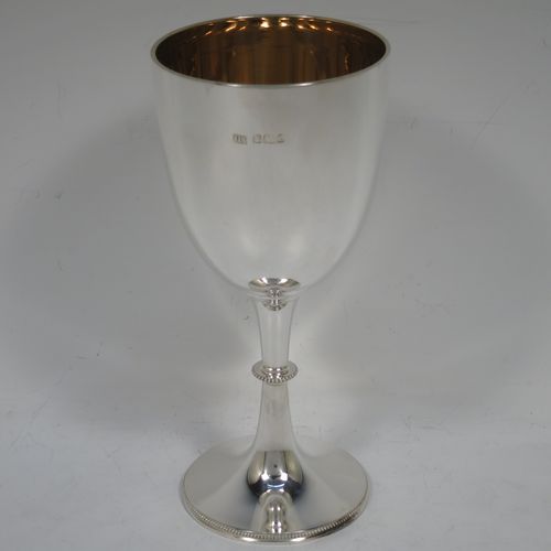 A handsome Antique Edwardian Sterling Silver goblet, having a plain round tapering body, and sitting on a pedestal foot with an applied bead-edged border, and a gold-gilt interior. Made by Henry Atkins of Sheffield in 1903. The dimensions of this fine hand-made antique silver goblet are height 17.5 cms (6.75 inches), diameter at lip 8 cms (3 inches), and it weighs approx. 147g (4.7 troy ounces).    