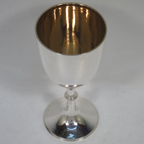 A handsome Antique Edwardian Sterling Silver goblet, having a plain round tapering body, and sitting on a pedestal foot with an applied bead-edged border, and a gold-gilt interior. Made by Henry Atkins of Sheffield in 1903. The dimensions of this fine hand-made antique silver goblet are height 17.5 cms (6.75 inches), diameter at lip 8 cms (3 inches), and it weighs approx. 147g (4.7 troy ounces).    