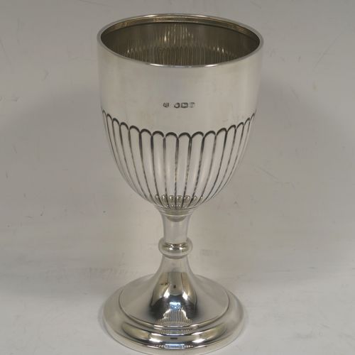 A very elegant Sterling Silver goblet, having a round tapering body with hand-chased half-fluted decoration, and sitting on a stepped pedestal foot. This handsome silver goblet was made by James and Walter Deakin of Sheffield in 1927. The dimensions of this fine hand-made silver goblet are height 15 cms (6 inches), diameter at lip 8 cms (3 inches), and it weighs approx. 113g (3.6 troy ounces).   