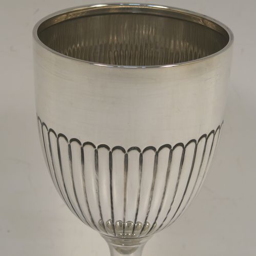 A very elegant Sterling Silver goblet, having a round tapering body with hand-chased half-fluted decoration, and sitting on a stepped pedestal foot. This handsome silver goblet was made by James and Walter Deakin of Sheffield in 1927. The dimensions of this fine hand-made silver goblet are height 15 cms (6 inches), diameter at lip 8 cms (3 inches), and it weighs approx. 113g (3.6 troy ounces).   