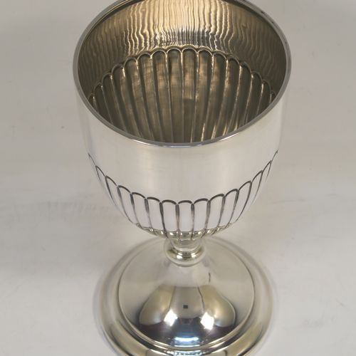 A very elegant Sterling Silver goblet, having a round tapering body with hand-chased half-fluted decoration, and sitting on a stepped pedestal foot. This handsome silver goblet was made by James and Walter Deakin of Sheffield in 1927. The dimensions of this fine hand-made silver goblet are height 15 cms (6 inches), diameter at lip 8 cms (3 inches), and it weighs approx. 113g (3.6 troy ounces).   