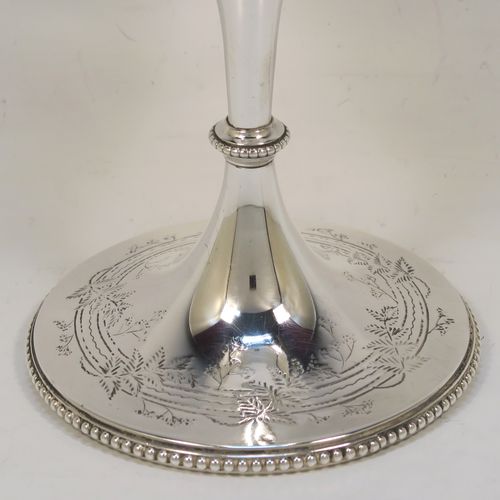 A very pretty Antique Victorian Sterling Silver goblet, having a round straight-sided and bellied body with hand-engraved floral and fern decoration, a gold-gilt interior, and sitting on a pedestal foot with hand-engraved decoration and an applied bead-edged border. This beautiful antique silver goblet was made by Frederick Elkington of London in 1873. The dimensions of this fine hand-made antique silver goblet are height 18.5 cms (7.25 inches), diameter at lip 9 cms (3.5 inches), and it weighs approx. 205g (6.6 troy ounces).   