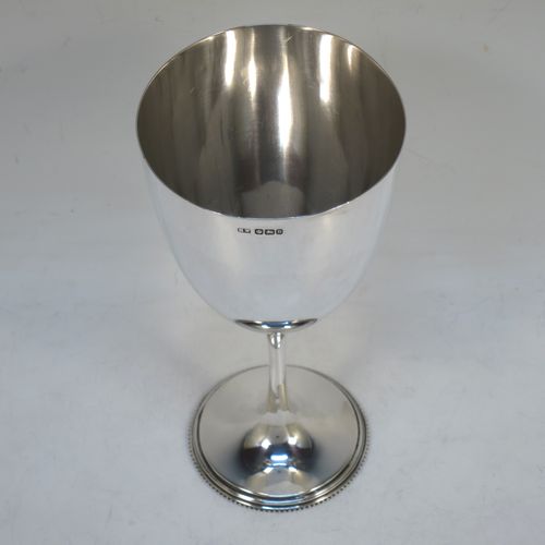 A handsome Antique Victorian Sterling Silver goblet, having a plain round tapering body, and sitting on a plain pedestal foot with an applied bead border. Made by Henry Wilkinson of Sheffield in 1900. The dimensions of this fine hand-made antique silver goblet are height 16.5 cms (6.5 inches), diameter at lip 8 cms (3.25 inches), and it weighs approx. 142g (4.6 troy ounces).  