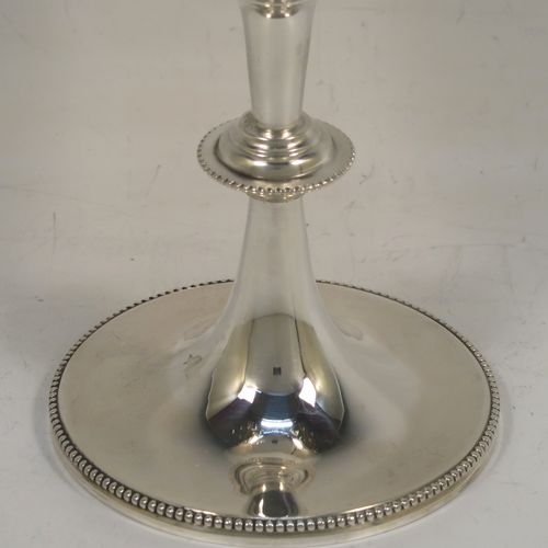 A large and very pretty Antique Victorian Sterling Silver goblet, having a round tapering body with hand-engraved floral and scroll decoration surrounding two round vacant cartouches on either side, sitting on a pedestal foot with applied bead-edged borders, and with a gold-gilt interior. This beautiful antique silver wine goblet was made by Charles Stuart Harris of London in 1887. The dimensions of this fine hand-made antique silver goblet are height 18.5 cms (7.25 inches), diameter at lip 8.5 cms (3.3 inches), and it weighs approx. 224g (7.2 troy ounces).