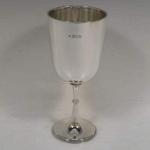 A very handsome Antique Sterling Silver large goblet, having a plain round tapering body, and sitting on a plain pedestal foot with an applied bead border. This beautiful antique silver goblet was made by Jackson and Fullerton of London in 1913. The dimensions of this fine hand-made antique silver goblet are height 18.5 cms (7.3 inches), diameter at lip 8 cms (3.25 inches), and it weighs approx. 189g (6 troy ounces).  