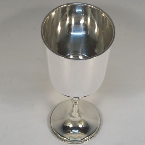 A very handsome Antique Sterling Silver large goblet, having a plain round tapering body, and sitting on a plain pedestal foot with an applied bead border. This beautiful antique silver goblet was made by Jackson and Fullerton of London in 1913. The dimensions of this fine hand-made antique silver goblet are height 18.5 cms (7.3 inches), diameter at lip 8 cms (3.25 inches), and it weighs approx. 189g (6 troy ounces).  