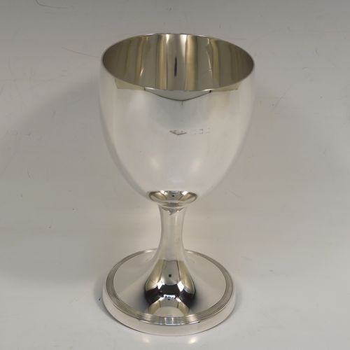 A very handsome Sterling Silver goblet, having a plain round tapering body, and sitting on a pedestal foot with a hand-engraved reeded border. This elegant silver wine goblet was made in London in 1928. The dimensions of this fine hand-made silver goblet are height 16 cms (6.3 inches), diameter at lip 9 cms (3.5 inches), and it weighs approx. 226g (7.3 troy ounces).   