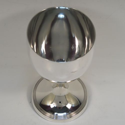 A very handsome Sterling Silver goblet, having a plain round tapering body, and sitting on a pedestal foot with a hand-engraved reeded border. This elegant silver wine goblet was made in London in 1928. The dimensions of this fine hand-made silver goblet are height 16 cms (6.3 inches), diameter at lip 9 cms (3.5 inches), and it weighs approx. 226g (7.3 troy ounces).   