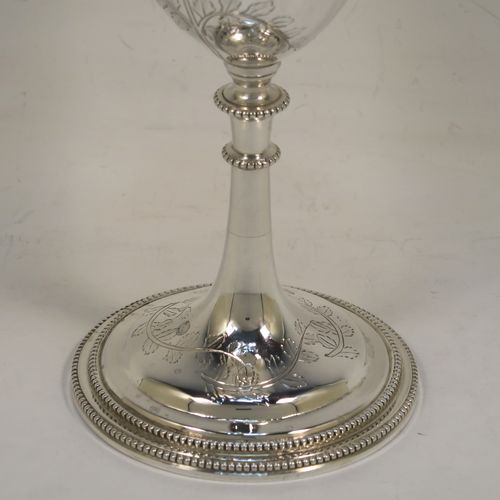 A very pretty Antique Victorian Sterling Silver goblet, having a round bellied body with hand-engraved tree and leaf floral decoration, a gold-gilt interior, and sitting on a pedestal foot with an applied double bead-edged border. This beautiful silver goblet was made by Thomas Smiley of London in 1870. The dimensions of this fine hand-made antique silver goblet are height 16.5 cms (6.5 inches), diameter at lip 8 cms (3.25 inches), and it weighs approx. 172g (5.5 troy ounces).   