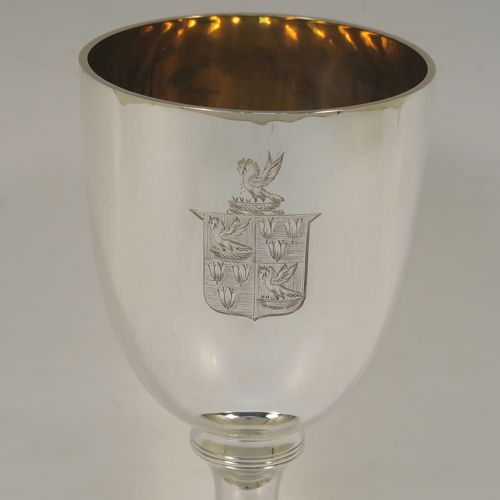 A very handsome Antique Victorian Sterling Silver goblet, having a plain round tapering body with a gold-gilt interior, and sitting on a pedestal foot with an applied upper reeded band. This elegant antique silver wine goblet was made by the Harris Brothers of London in 1897. The dimensions of this fine hand-made antique silver goblet are height 18 cms (7 inches), diameter at lip 9 cms (3.5 inches), and it weighs approx. 257g (8.3 troy ounces). Please note that this item is crested on one side. 