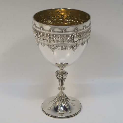 A fantastic Antique Victorian Sterling Silver goblet, having a hand-chased body with bead and floral decoration, a gold-gilt interior, a cast stem with acanthus leaf and bead-work, and sitting on a pedestal foot with a bead-edged border. This beautiful and unique goblet was made by William Edwards of London in 1890. The dimensions of this fine hand-made antique silver goblet are height 16 cms (6.3 inches), diameter at lip 8.5 cms (3.3 inches), and it weighs approx. 188g (6 troy ounces).   