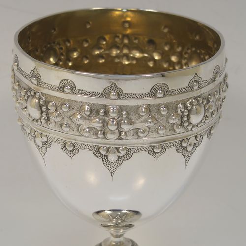 A fantastic Antique Victorian Sterling Silver goblet, having a hand-chased body with bead and floral decoration, a gold-gilt interior, a cast stem with acanthus leaf and bead-work, and sitting on a pedestal foot with a bead-edged border. This beautiful and unique goblet was made by William Edwards of London in 1890. The dimensions of this fine hand-made antique silver goblet are height 16 cms (6.3 inches), diameter at lip 8.5 cms (3.3 inches), and it weighs approx. 188g (6 troy ounces).   