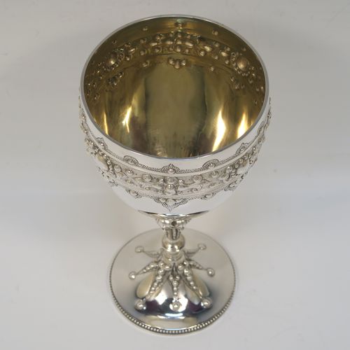 A fantastic Antique Victorian Sterling Silver goblet, having a hand-chased body with bead and floral decoration, a gold-gilt interior, a cast stem with acanthus leaf and bead-work, and sitting on a pedestal foot with a bead-edged border. This beautiful and unique goblet was made by William Edwards of London in 1890. The dimensions of this fine hand-made antique silver goblet are height 16 cms (6.3 inches), diameter at lip 8.5 cms (3.3 inches), and it weighs approx. 188g (6 troy ounces).   