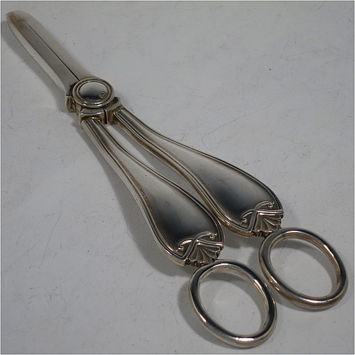 A very handsome and heavy Sterling Silver pair of grape shears or scissors in a double struck pattern with reeded borders and shell and scroll terminals. Made by Charles Boyton and Sons of Sheffield in 1931. The dimensions of this fine hand-made pair of  silver grape scissors or shears are length 18 cms (7 inches), and they weigh approx. 123g (4 troy ounces).    