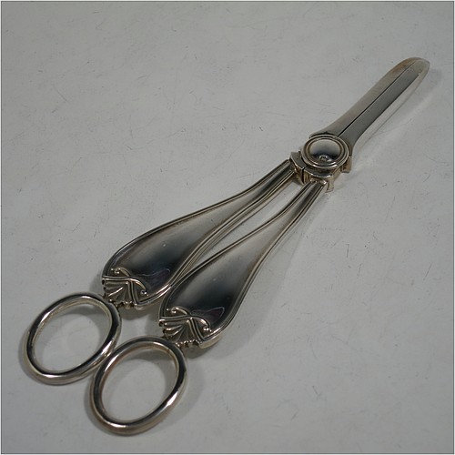 A very handsome and heavy Sterling Silver pair of grape shears or scissors in a double struck pattern with reeded borders and shell and scroll terminals. Made by Charles Boyton and Sons of Sheffield in 1931. The dimensions of this fine hand-made pair of  silver grape scissors or shears are length 18 cms (7 inches), and they weigh approx. 123g (4 troy ounces).    