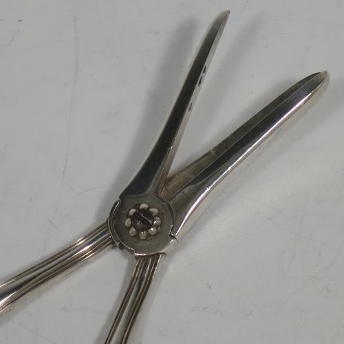 A very pretty Antique Victorian Sterling Silver pair of grape shears or scissors in the double struck Kings pattern with reeded handles. Made by Francis Higgins of London in 1893. The dimensions of this fine hand-made pair of antique silver grape scissors or shears are length 18 cms (7 inches), and they weigh approx. 124g (4 troy ounces).    