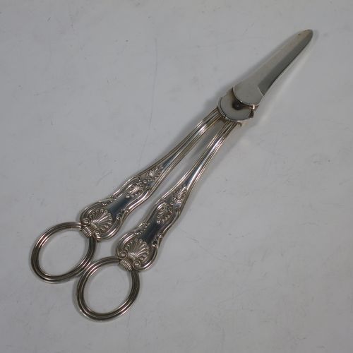 A very pretty Antique Victorian Sterling Silver pair of grape shears or scissors in the double struck Kings pattern with reeded handles. Made by Francis Higgins of London in 1893. The dimensions of this fine hand-made pair of antique silver grape scissors or shears are length 18 cms (7 inches), and they weigh approx. 124g (4 troy ounces).    