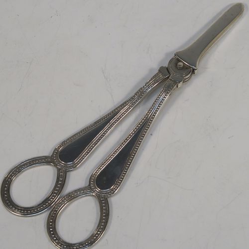 A very pretty Antique Victorian Sterling Silver pair of grape shears or scissors in the double struck Bead pattern. This beautiful pair of antique silver grape scissors were made by Henry Holland of London in 1878. The dimensions of this fine hand-made pair of antique silver grape shears are length 16.5 cms (6.5 inches), and they weigh approx. 81g (2.6 troy ounces).   