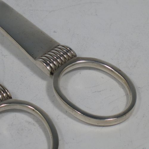 A handsome Art Deco style Sterling Silver pair of grape shears or scissors, with plain handles. Made by the Cooper Brothers of Sheffield in 1953. The dimensions of this fine hand-made pair of silver grape scissors or shears are length 16.5 cms (6.5 inches), and they weigh approx. 99g (3.2 troy ounces).    