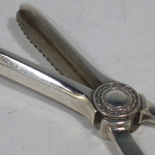 A handsome Art Deco style Sterling Silver pair of grape shears or scissors, with plain handles. Made by the Cooper Brothers of Sheffield in 1953. The dimensions of this fine hand-made pair of silver grape scissors or shears are length 16.5 cms (6.5 inches), and they weigh approx. 99g (3.2 troy ounces).    