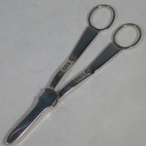 A handsome Art Deco style Sterling Silver pair of grape shears or scissors, with plain handles. Made by the Cooper Brothers of Sheffield in 1953. The dimensions of this fine hand-made pair of silver grape scissors or shears are length 16.5 cms (6.5 inches), and they weigh approx. 99g (3.2 troy ounces).    