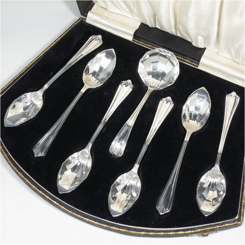 A Sterling Silver Art Deco set of six grape-fruit spoons and a sugar ladle, having panelled pointed oval bowls, and reeded Art Deco Belmont pattern handles, all in original white satin and black velvet-lined presentation box. Made by Marson & Jones of Birmingham in 1931. The dimensions of these fine hand-made grapefruit spoons are length 15 cms (6 inches), and they weigh a total of 248g (8 troy ounces).    